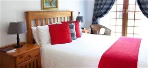 Cozy bedroom with a large bed wooden furniture and a window with curtains