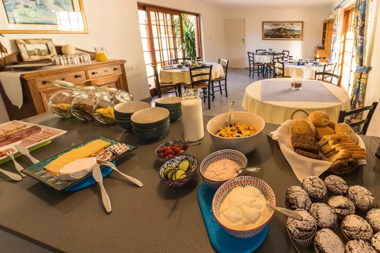 Breakfast buffet with pastries fruits and various dishes on a table