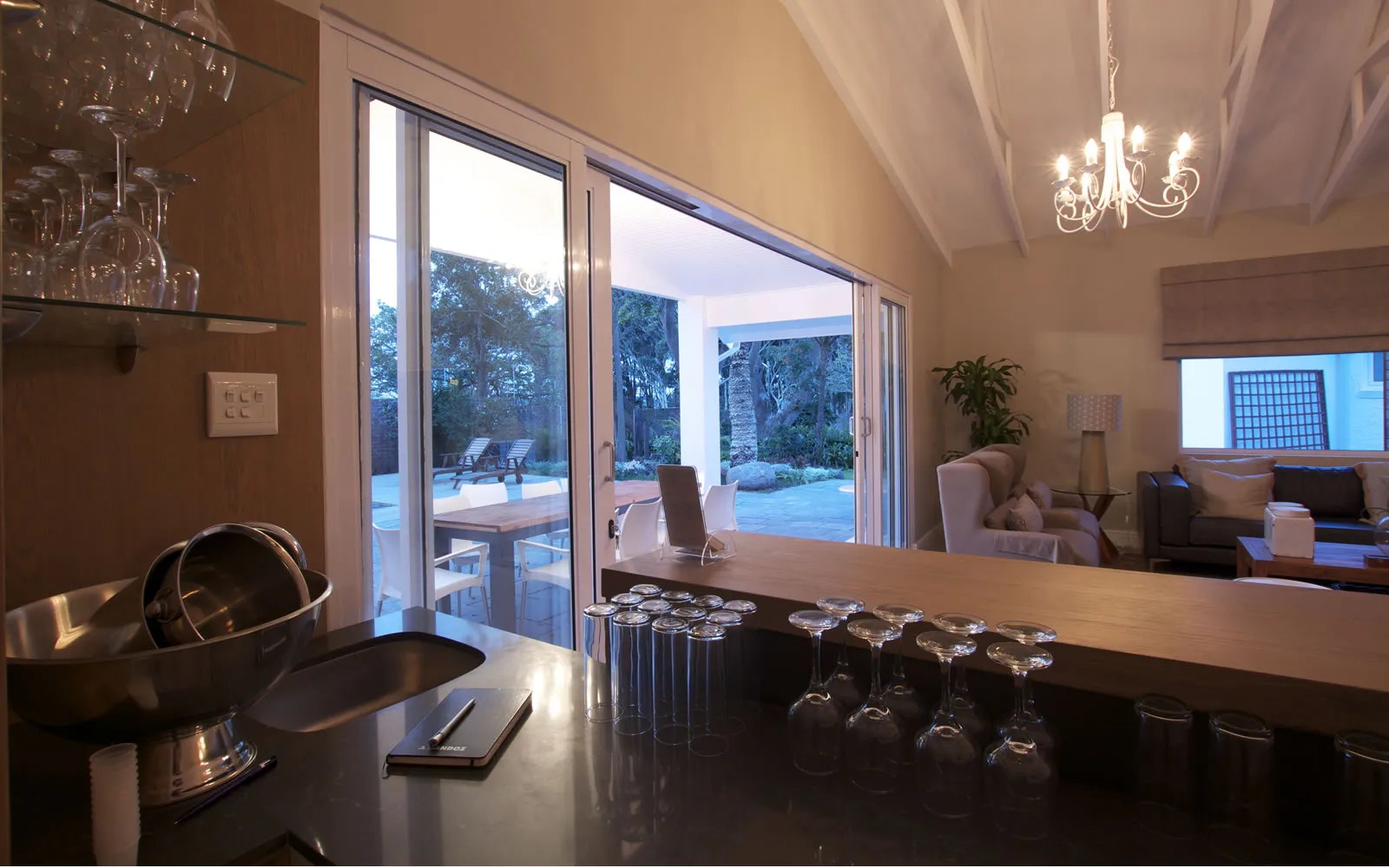 Modern kitchen with open sliding doors to a patio and living area