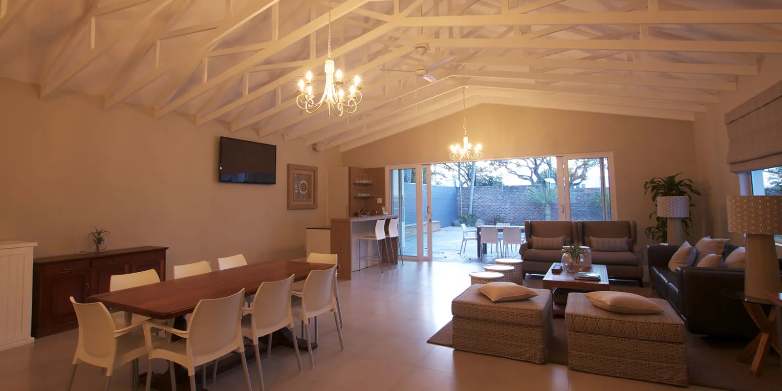 Open living area with dining table lounge and view to outdoor patio