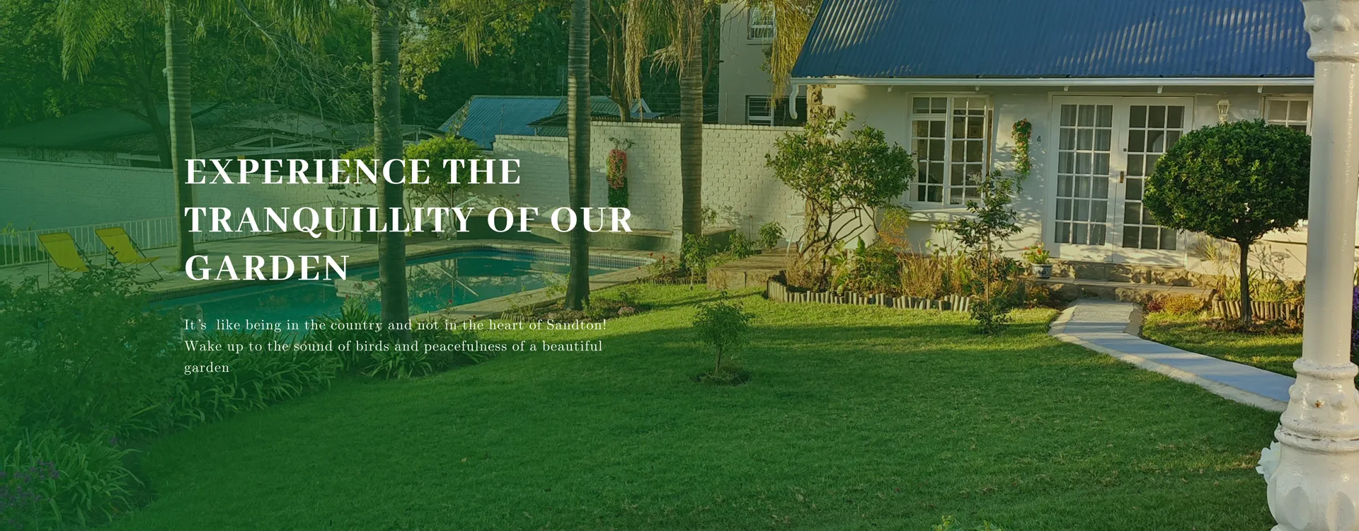 White house with garden palm trees and pathway in a tranquil setting