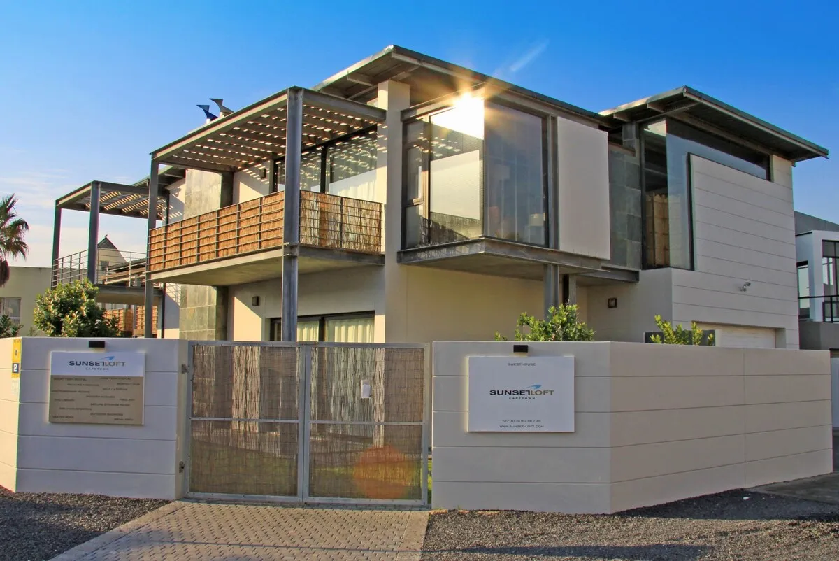 Modern twostory house with a balcony and a gated entrance