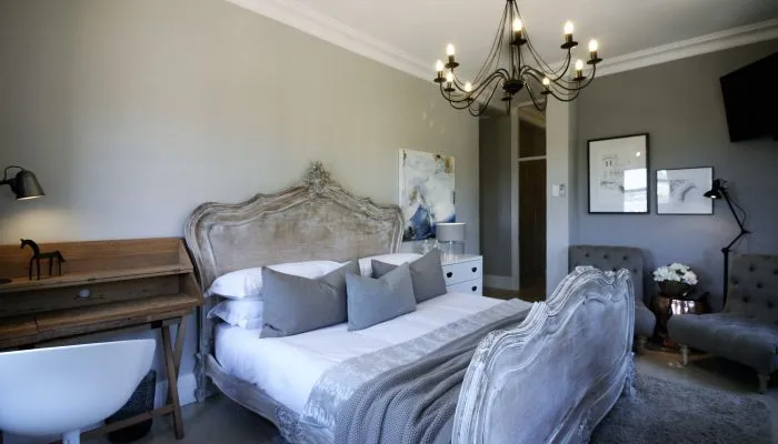 Elegant bedroom with ornate bed chandelier and modern decor