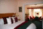 Blurry image of a bedroom with a bed and pillows