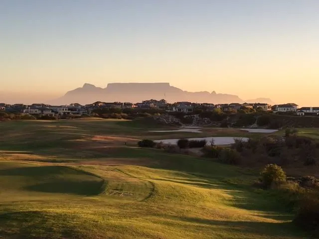 Golf course with distant mountain view at sunset