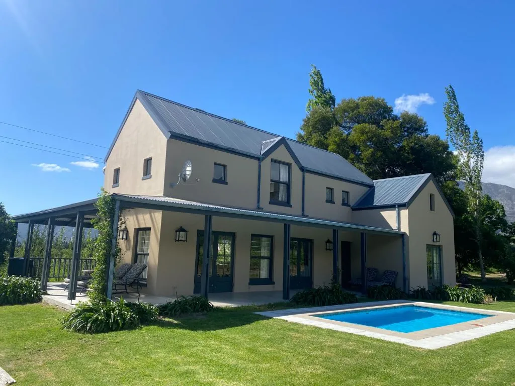 Modern house with a swimming pool in a sunny green garden