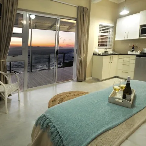 Modern bedroom with ocean view wine and cheese on a tray