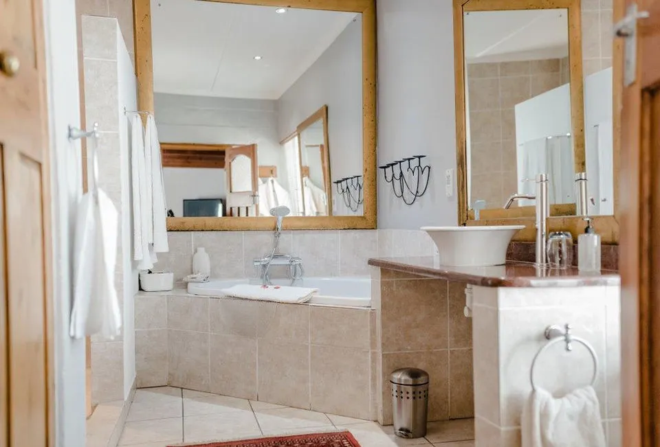 Modern bathroom with bathtub sink mirror and towels