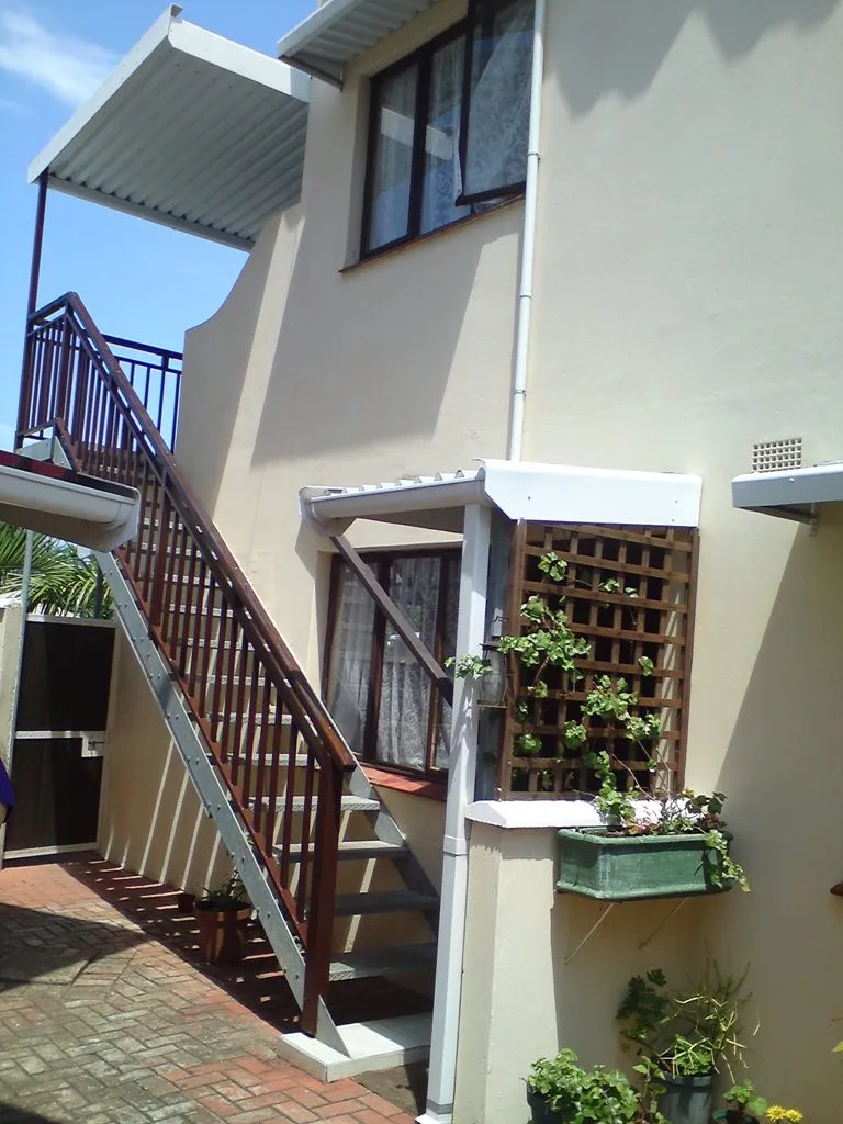 Staircase leading to upper level of a twostory house with plants