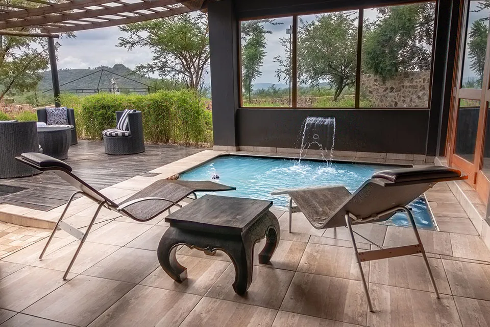 Modern outdoor lounge area with pool chairs and scenic view