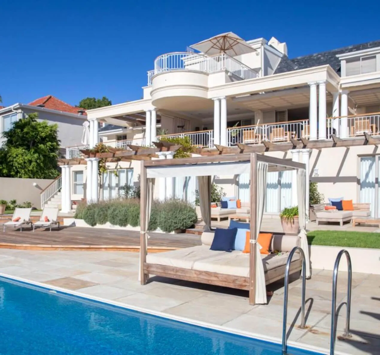 Luxury house with pool outdoor lounge area and blue sky