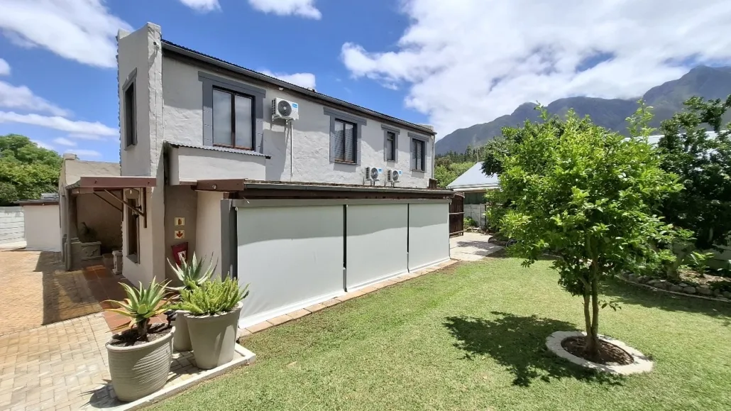 Modern twostory house with garden mountains in background