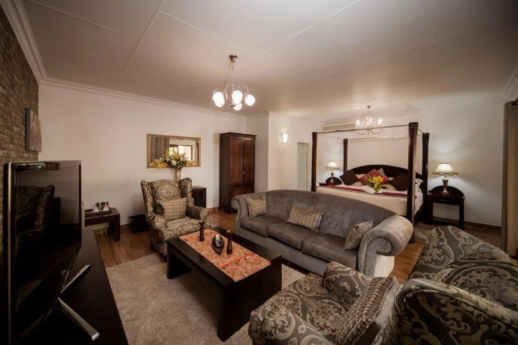 Cozy living room with TV sofas and a view into a bedroom