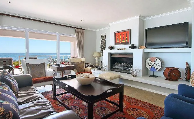 Living room with ocean view fireplace TV and modern furniture