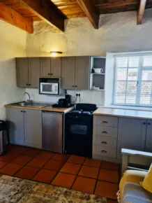 Cozy kitchen with wooden ceiling tiled floor and large window