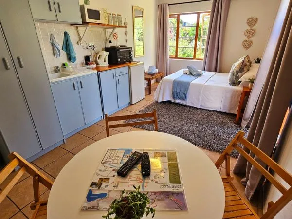 Cozy studio apartment with kitchenette bed and dining table