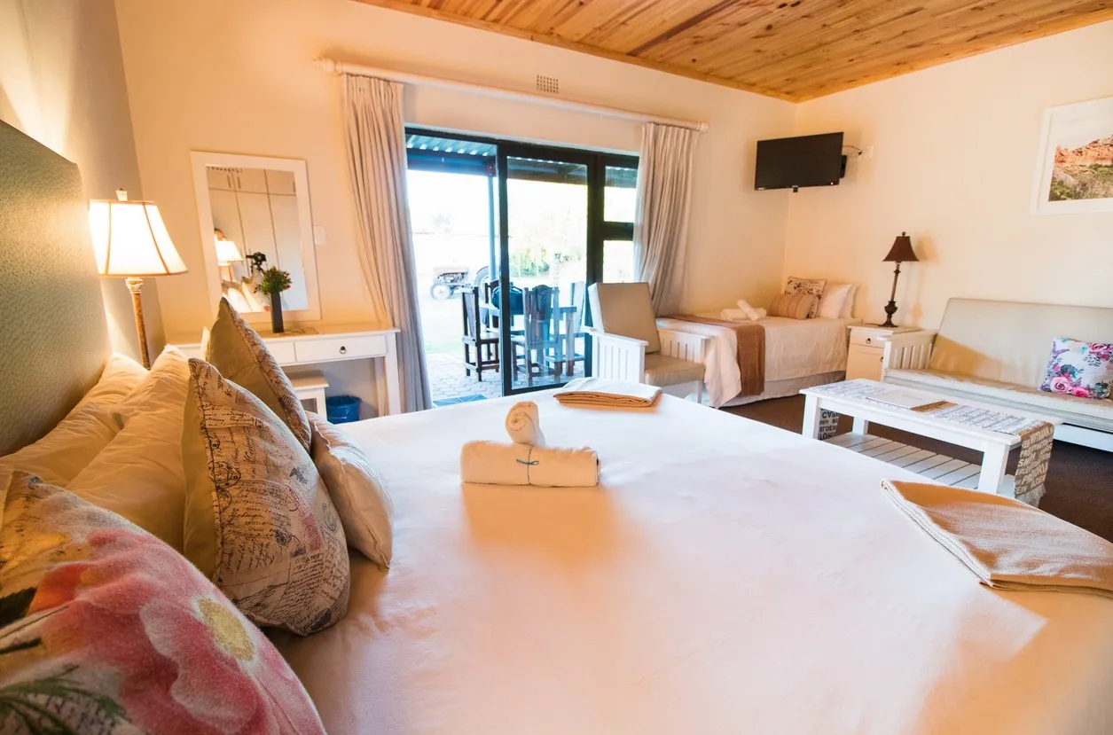 Cozy bedroom with large bed sofa and sliding door to patio