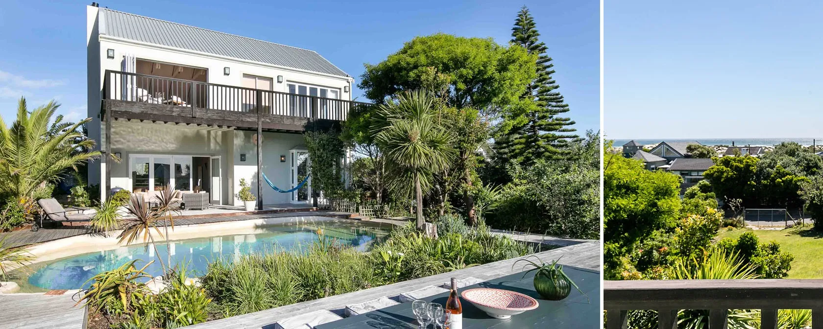 Twostory house with pool and garden and a view of a green landscape