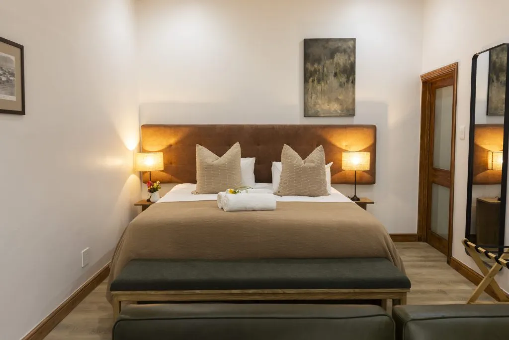 Cozy bedroom with a large bed bedside lamps and a wooden floor