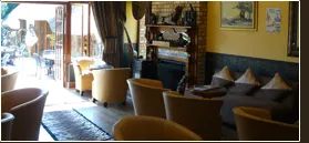 Cozy lounge with armchairs fireplace and outdoor seating area