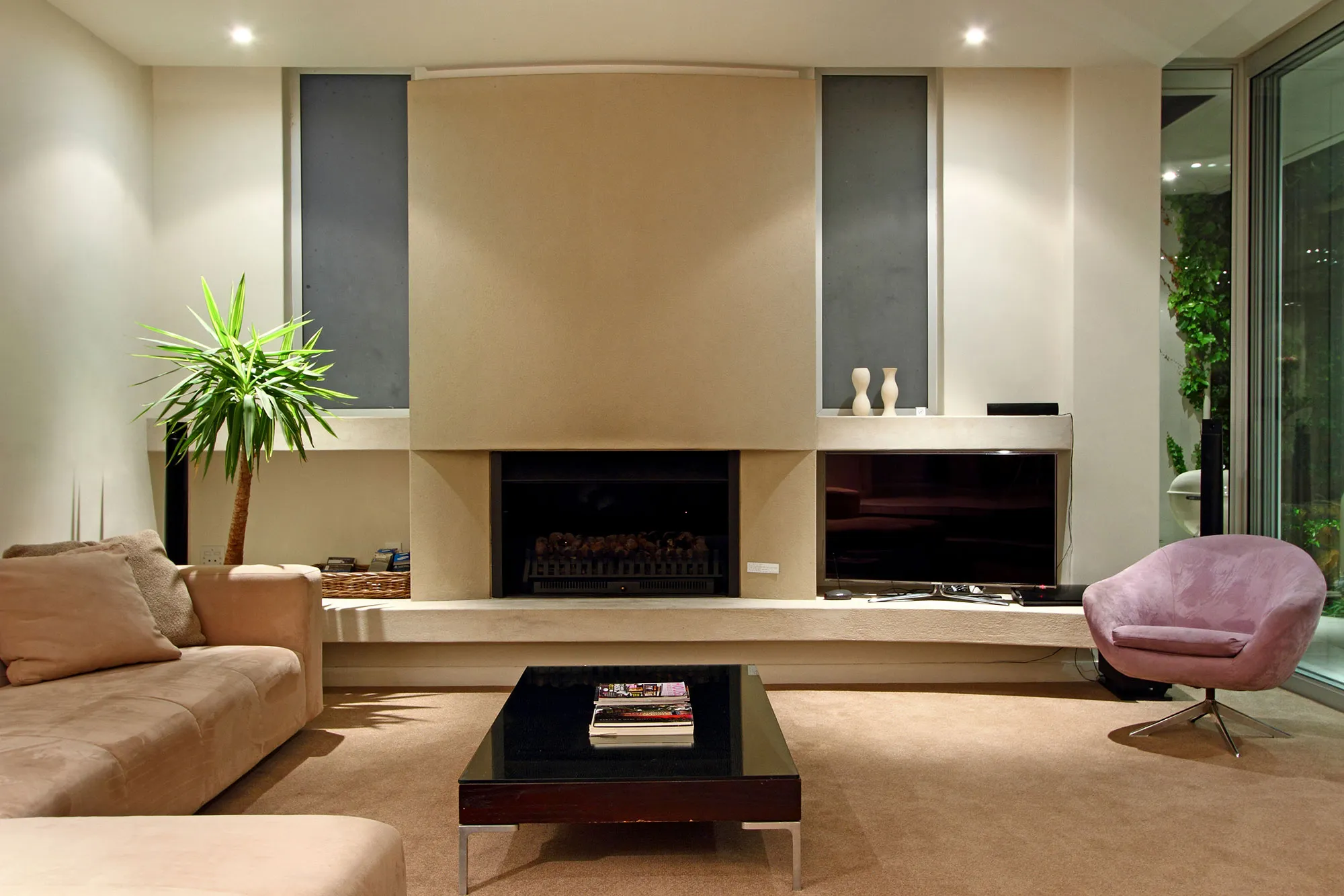 Modern living room with beige sofas coffee table and fireplace