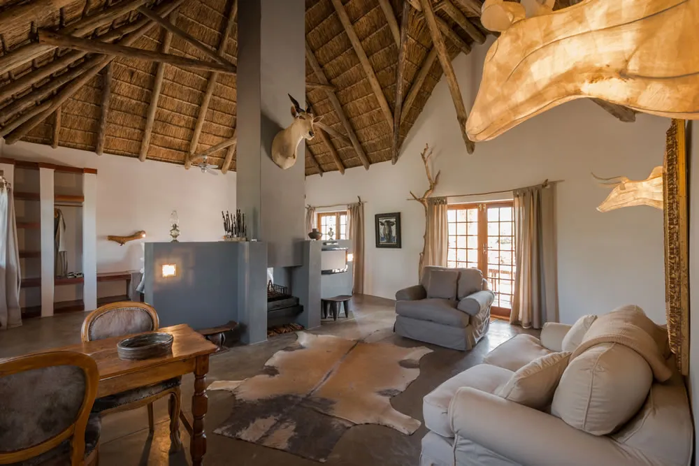 Safarithemed living room with animal decor wooden furniture and large windows