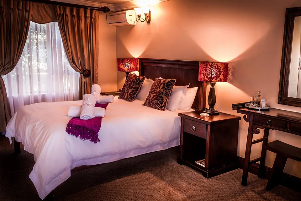 Cozy bedroom with a large bed bedside table and warm lighting